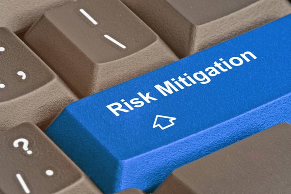Section of a computer keyboard with a key that has the words risk mitigation on it