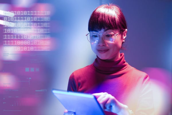 Businesswoman looking at a tablet in a futuristic office