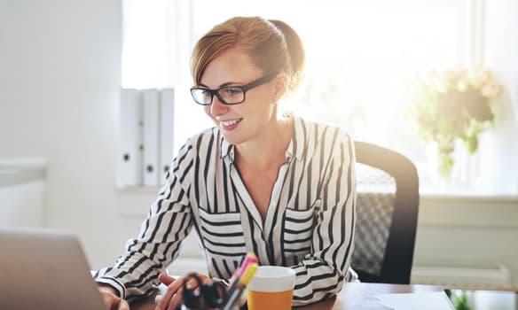 Woman working on computer | invoice processing with DocuWare for small business