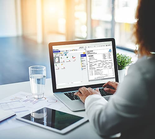 Lady typing and working on a laptop | Financial document management