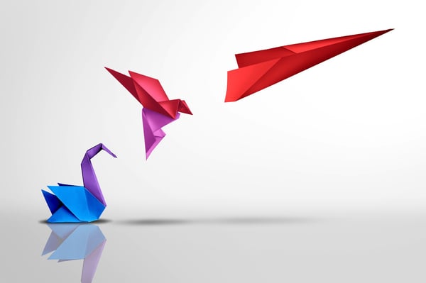 Paper origami of a swan transforming into a bird in flight and then an airplane represents the concept of change for the better