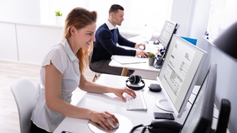 Two employees processing invoices resized2