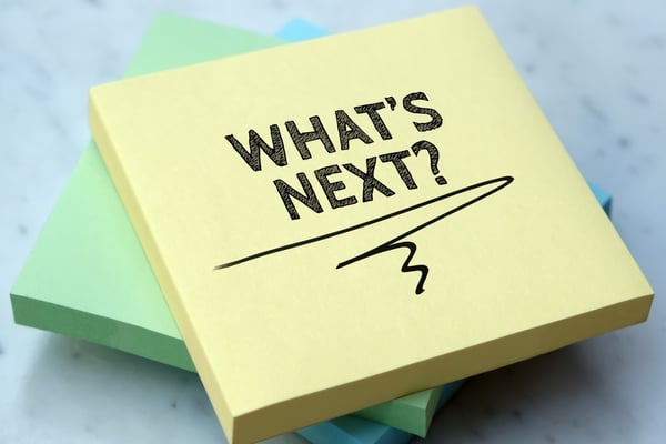 The words "What's next" written on a yellow post-it